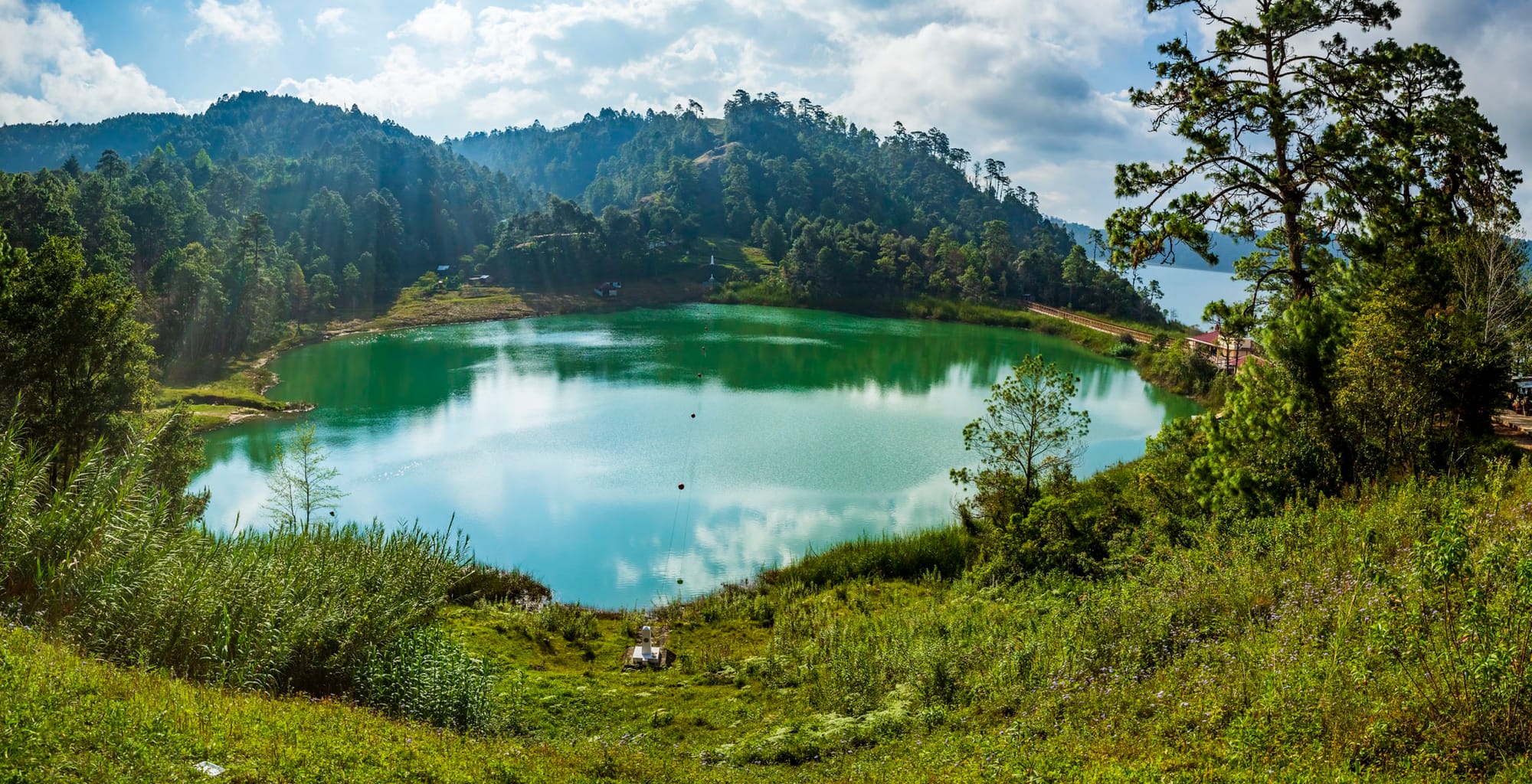 The border between Guatemala (left of the international markers) and Mexico with a small part of a lake lying across the border.