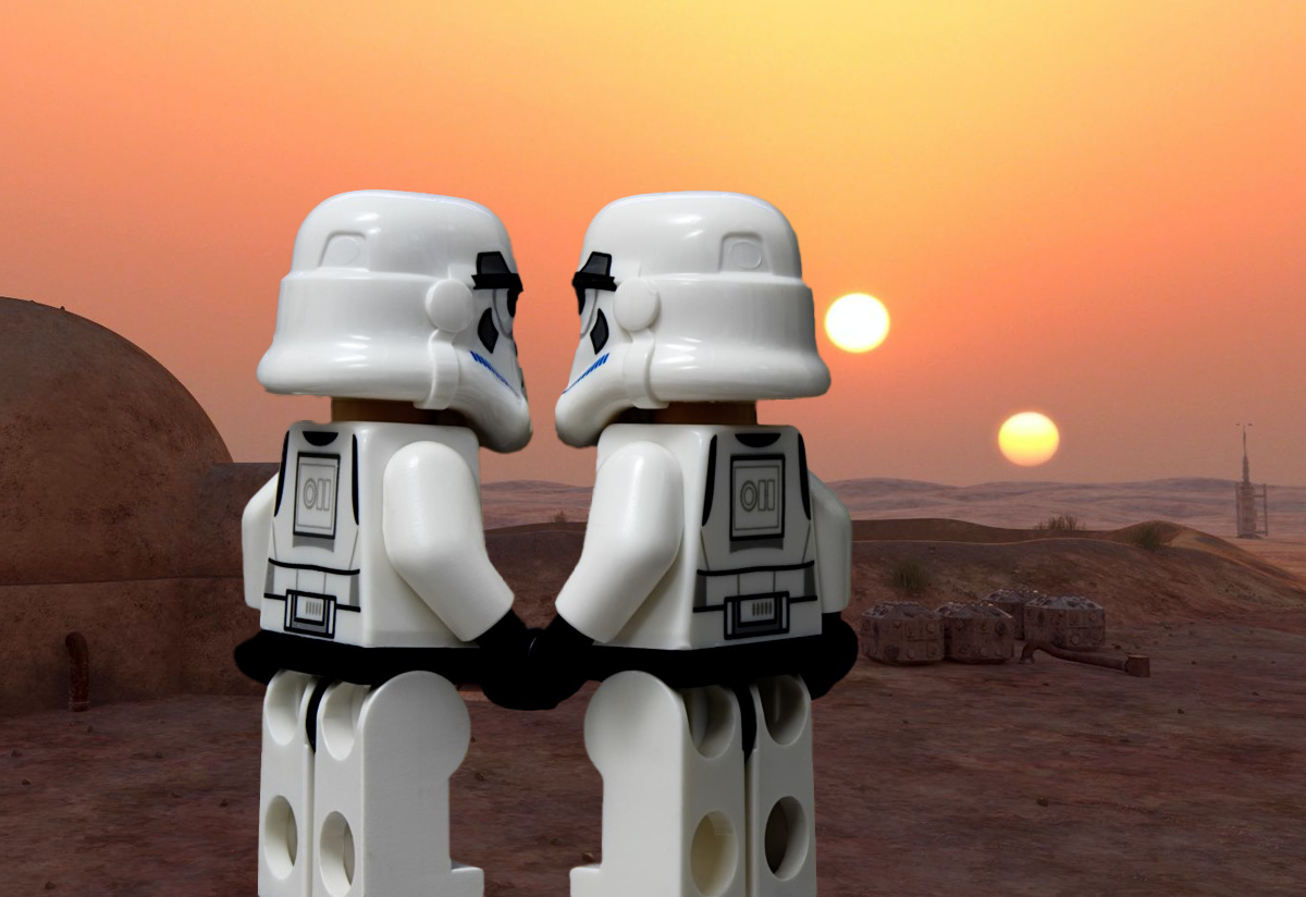 Two Lego Stormtroopers from Star Wars holding hands on Tattooine with its binary suns. Coffee?