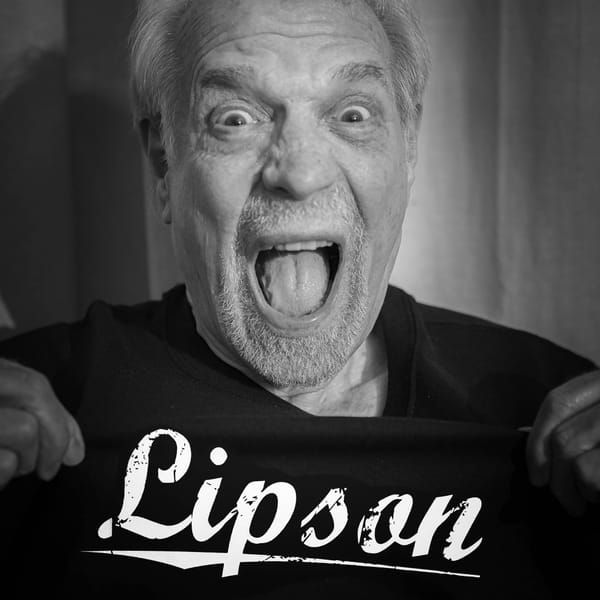 Ira Ira Lipson, mouth agape, in a black t-shirt with the word "Lipson" on the front.
