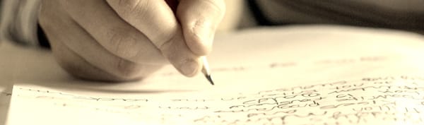 Man writing with pencil