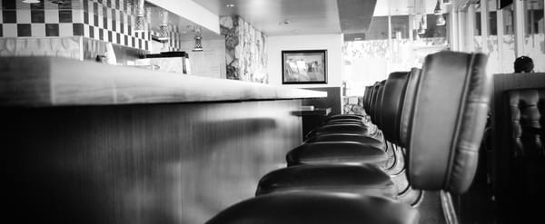 The perfect place to have breakfast for dinner and kill some time. A diner with an empty counter.