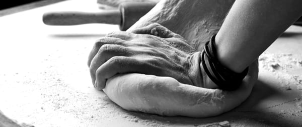 Hands kneading dough.